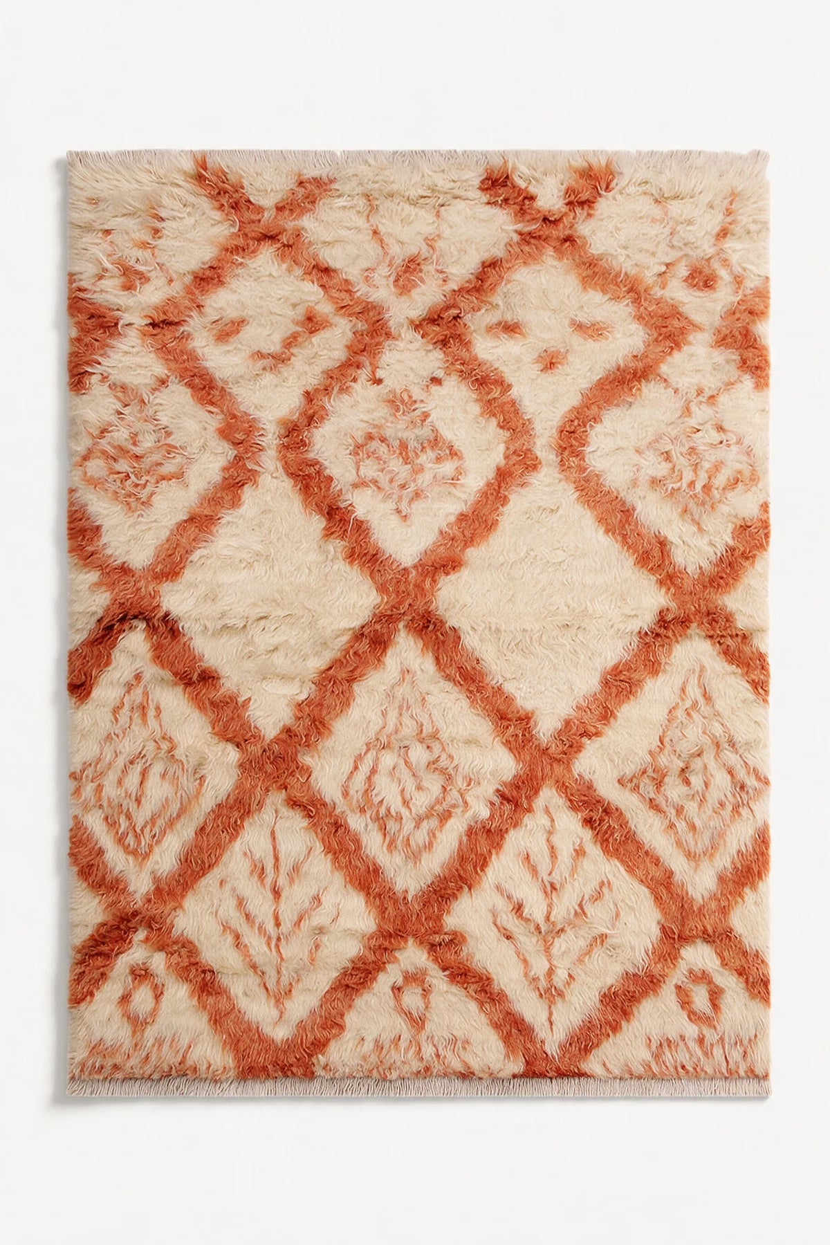 Cream and burnt orange wool shag rug in 8x10 size with diamond motif, perfect for adding texture to boho, eclectic, or modern living spaces