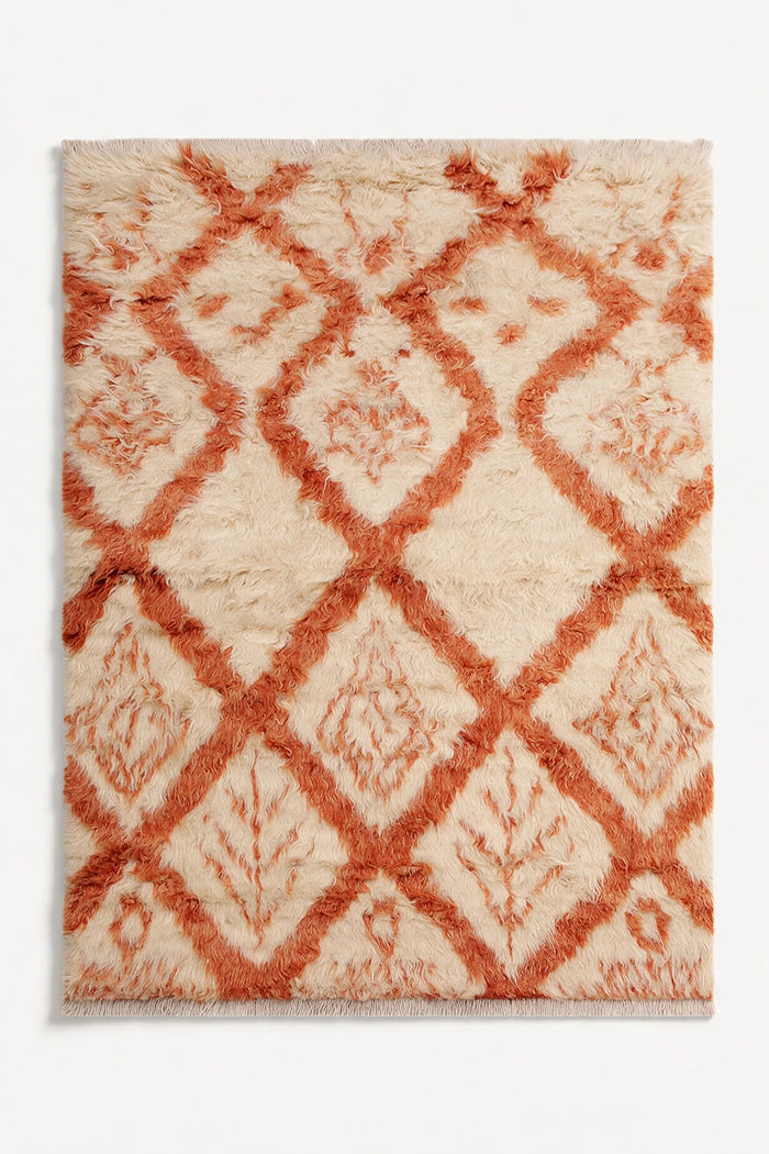 Cream and burnt orange wool shag rug in 8x10 size with diamond motif, perfect for adding texture to boho, eclectic, or modern living spaces