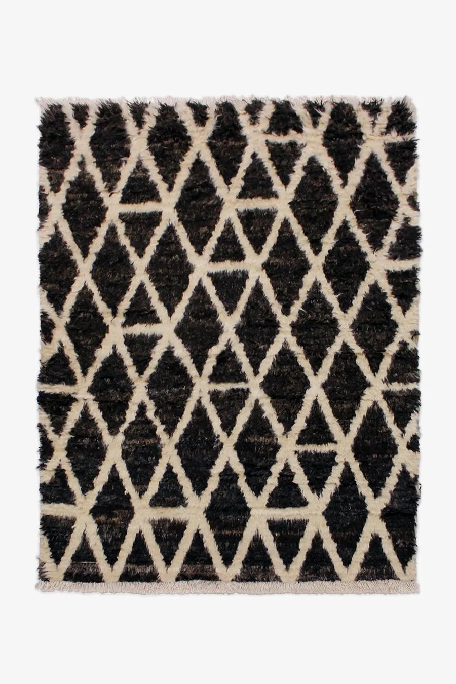 Black and cream Moroccan-inspired wool shag rug in 8x10 size, perfect for cozy living rooms and boho modern interiors
