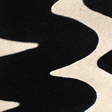 Bold black and ivory tufted rug with graphic shapes, ideal as a statement 5x8 or 6x9 modern rug