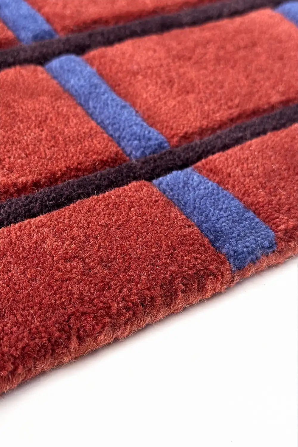 Close-up of a red and blue striped rug on a white background