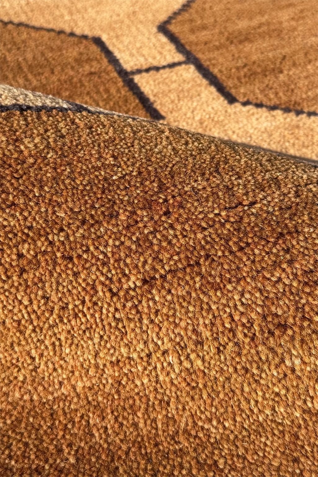Close-up of warm gold patterned runner rug on a floor