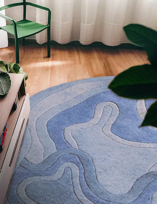 Irregular shaped blue wool rug with curved edges, perfect as a playful 5x7 rug or custom shape option