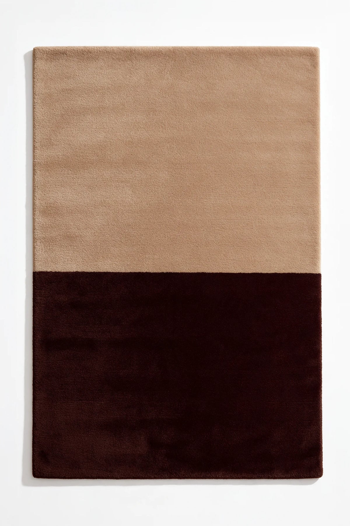 Soft neutral tan and deep brown wool rug, a warm modern addition to bedrooms, home offices, or cozy minimalist homes hazelnut