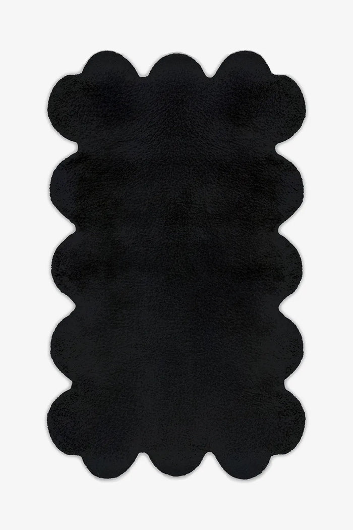 8x10 black scalloped wool rug with sculptural hand-tufted edges, perfect for modern minimalist living rooms