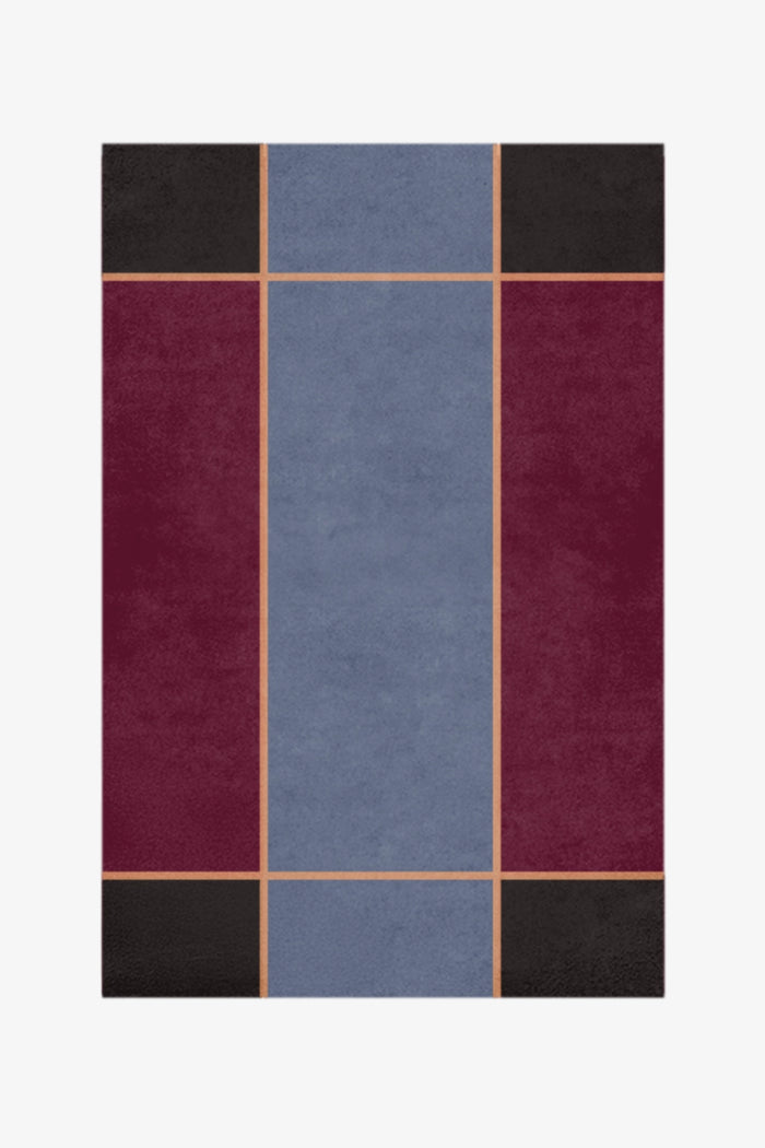 Rectangular rug with a geometric pattern of squares in blue, red, and black on a white background