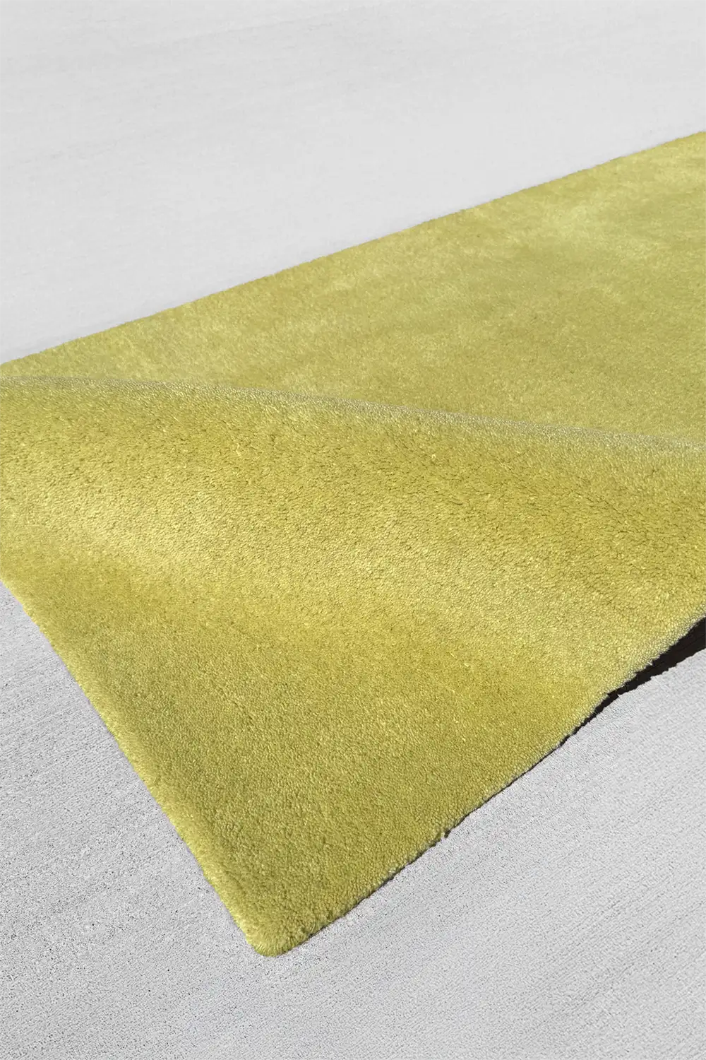 yellow green wool runner rug on a light gray floor