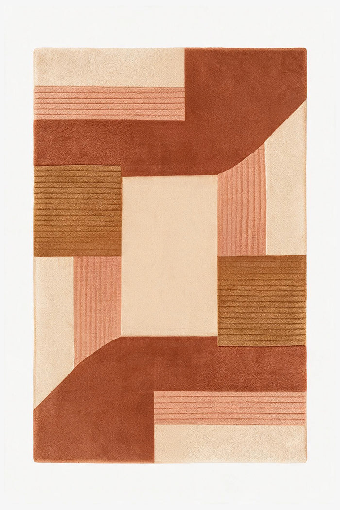 An abstract geometric area rug with a modern patchwork design in terracotta, dusty rose, tan, and cream, shown flat against a white background.