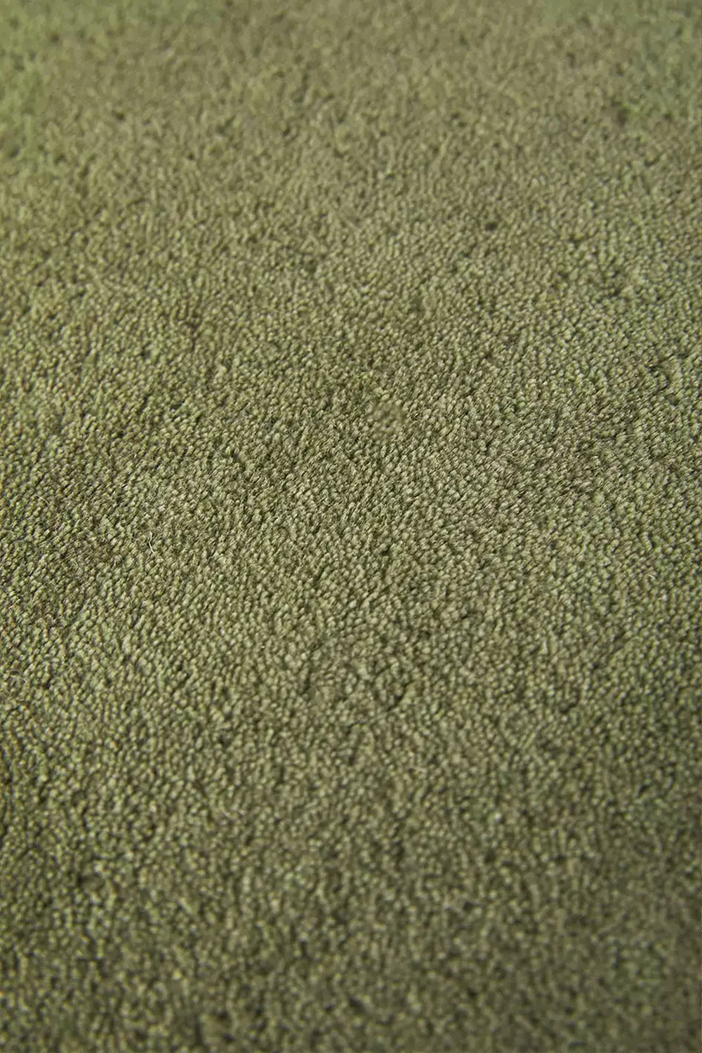 Close-up of green wool runner texture, organic modern green area rug for entryways