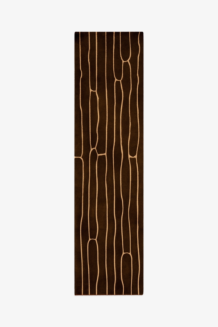 wool runner rug with brown abstract pattern on a white background