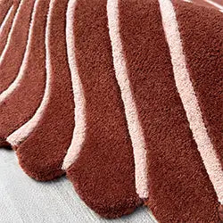 close-up of textured modern wool area rug with scalloped edges