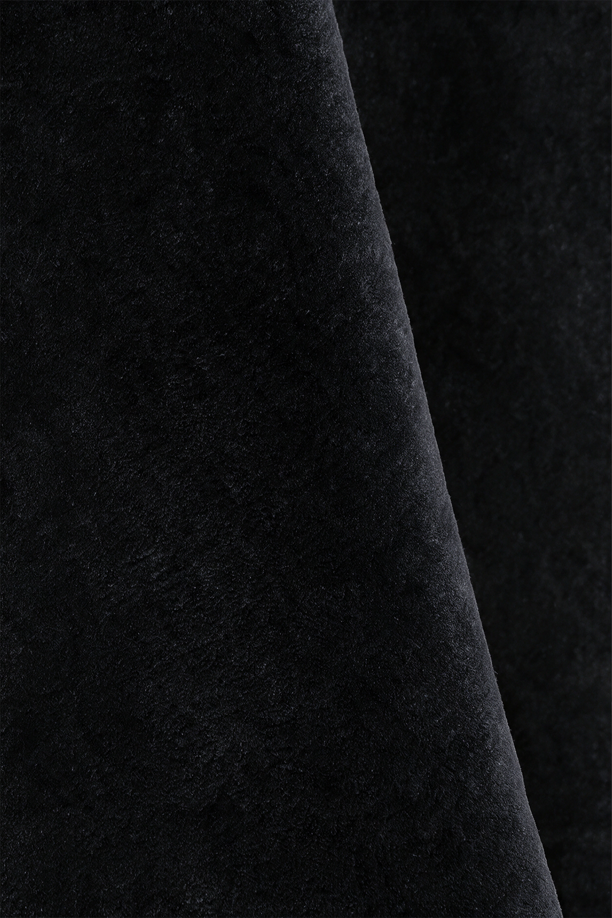 Close-up of black wool hand-tufted rug texture
