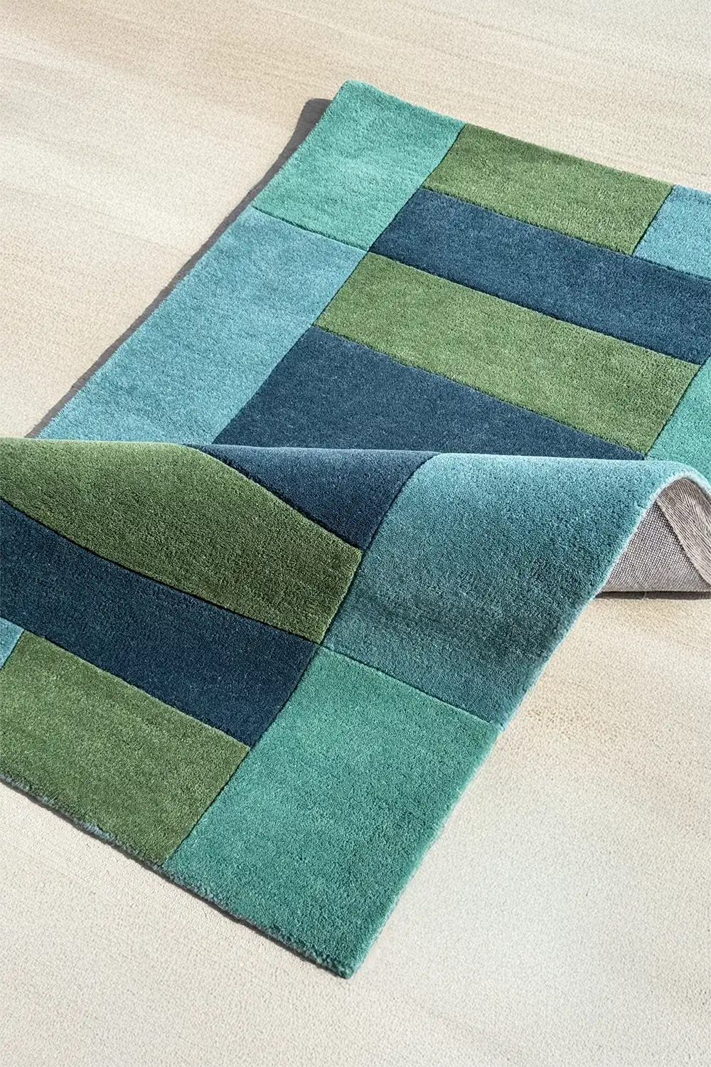 Blue and green color block rug with graphic stripes, ideal as an 8x10 coastal or tropical area rug