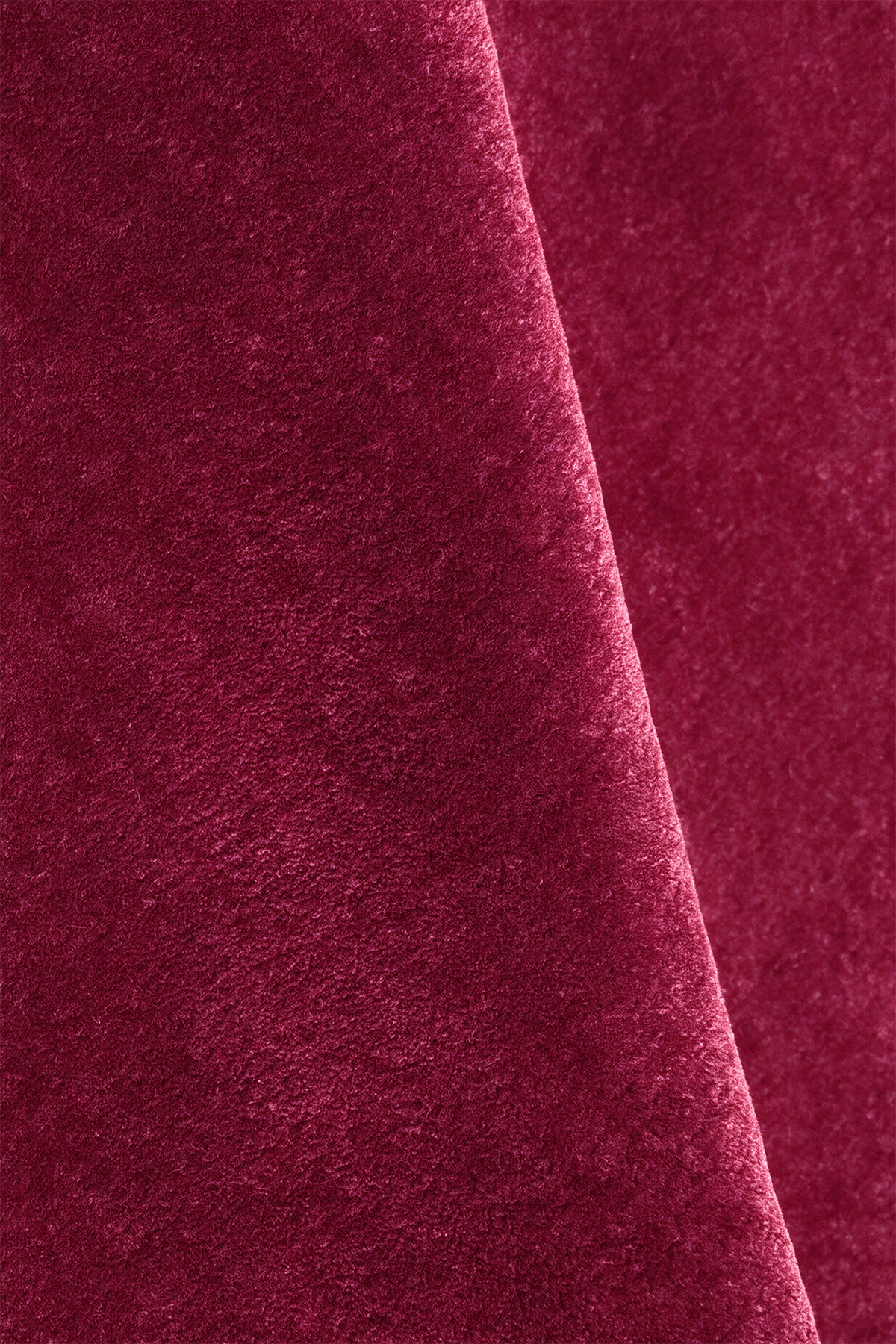 Close-up of burgundy purple pink wool rug texture