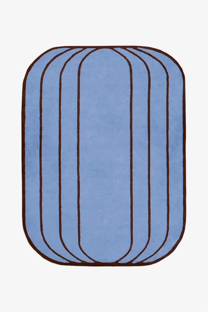 custom blue wool rug with brown rim on a white background