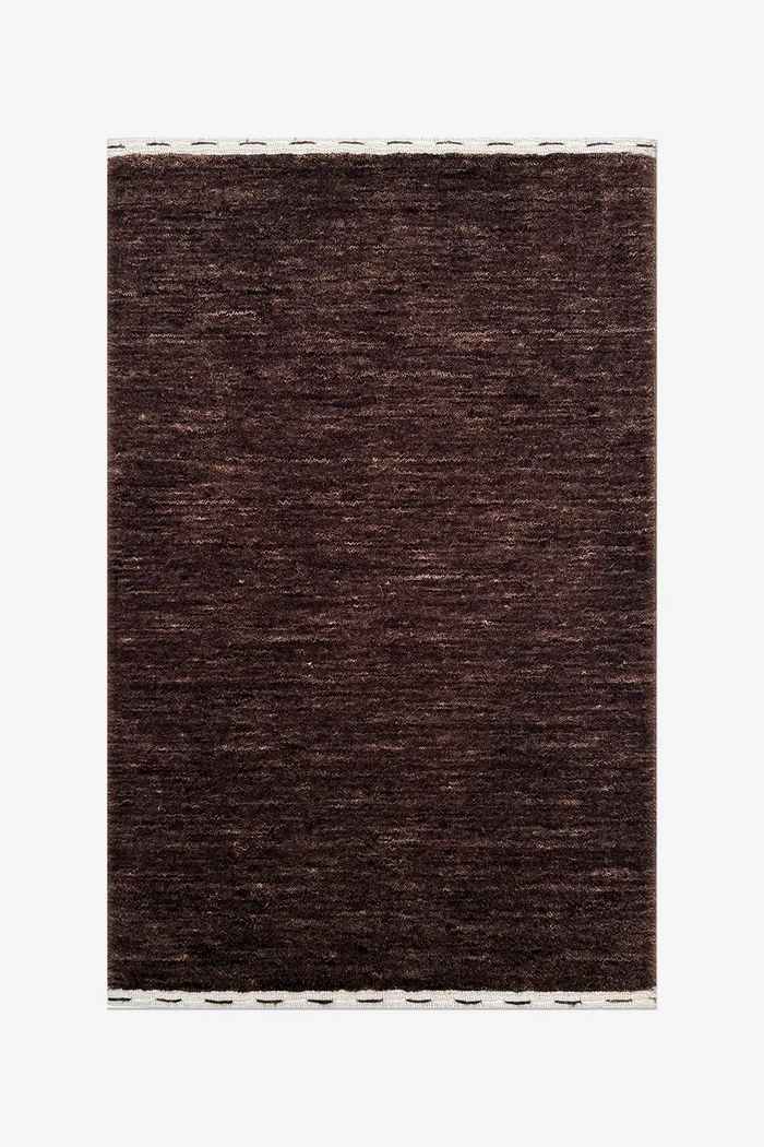 dark chocolate brown textured wool rug on a white background cocoa
