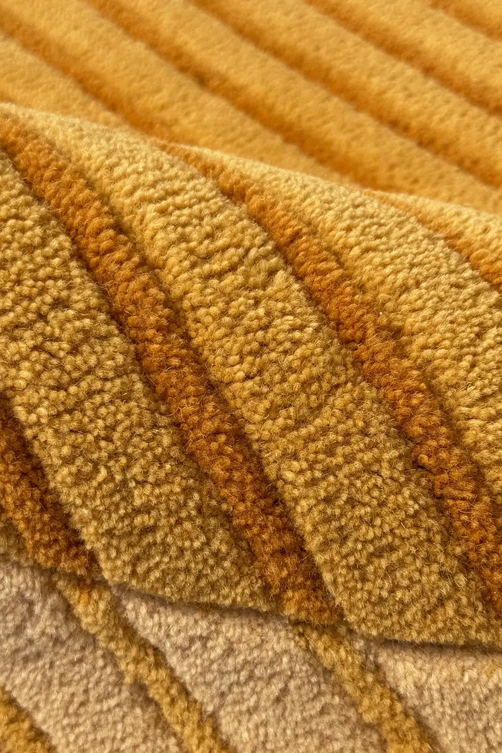 Close-up of textured wool yellow and gold carpet