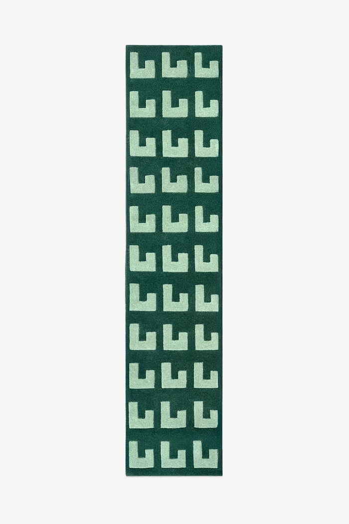 Green patterned runner rug on a white background