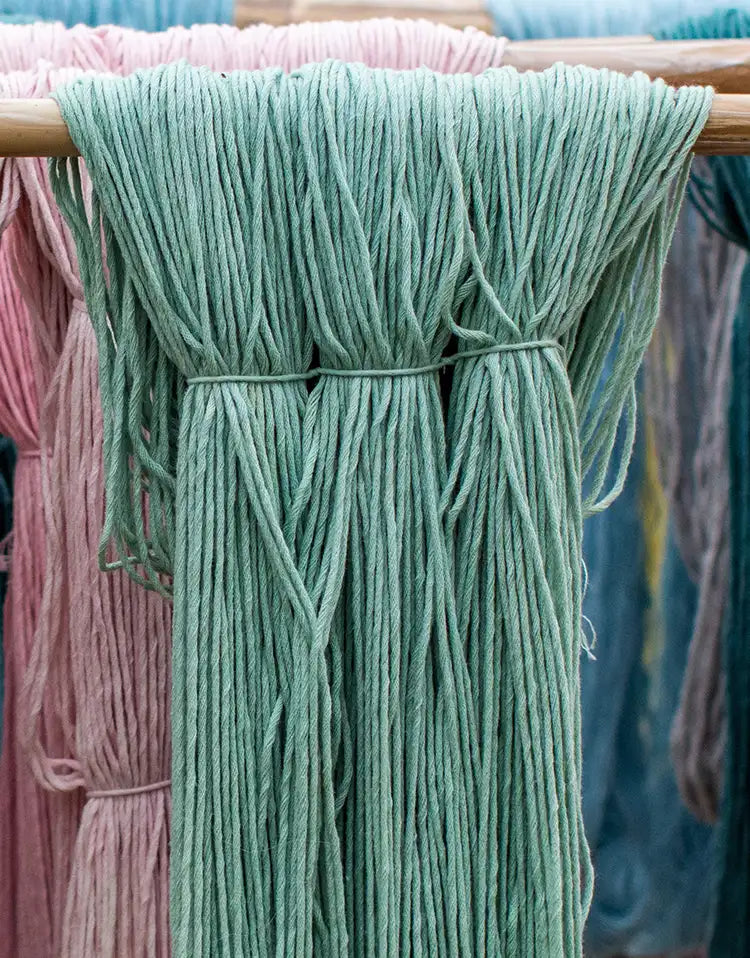 Rows of pastel-dyed New Zealand wool yarn hanging to dry