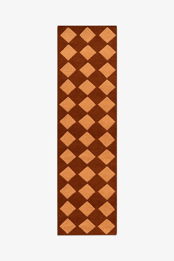 brown runner rug with geometric diamond pattern hand-tufted in wool on a white background