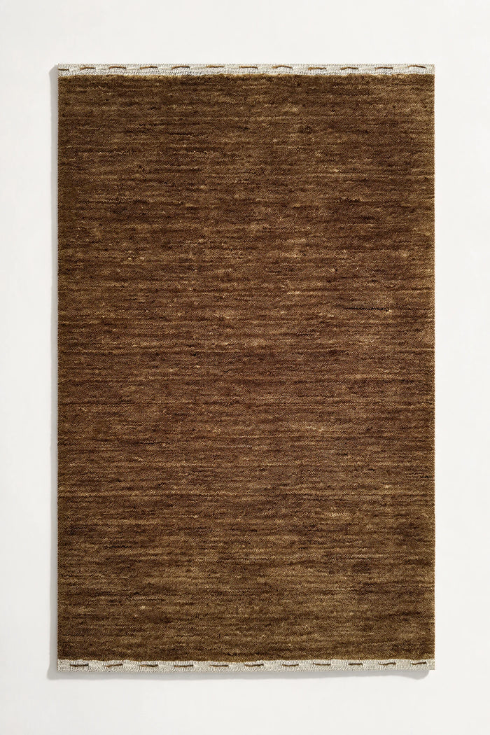 taupe golden brown textured rug on a white background hazel | Haven in Hazel with stitched binding