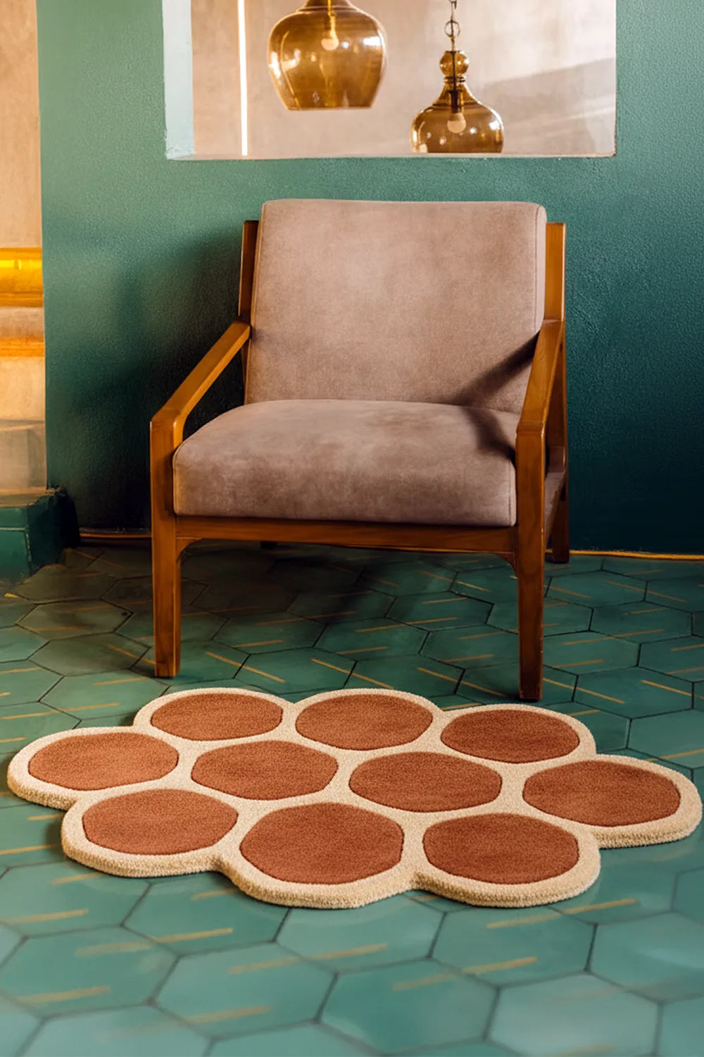 Chair with a decorative geometric patterned wool rug on a teal tiled floor lifestyle | Shown in 3x5