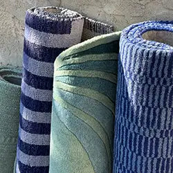 Three textured rugs with different patterns on a neutral background