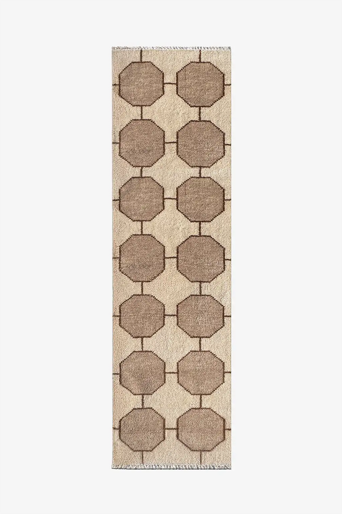 cream runner rug with geometric pattern on a plain background