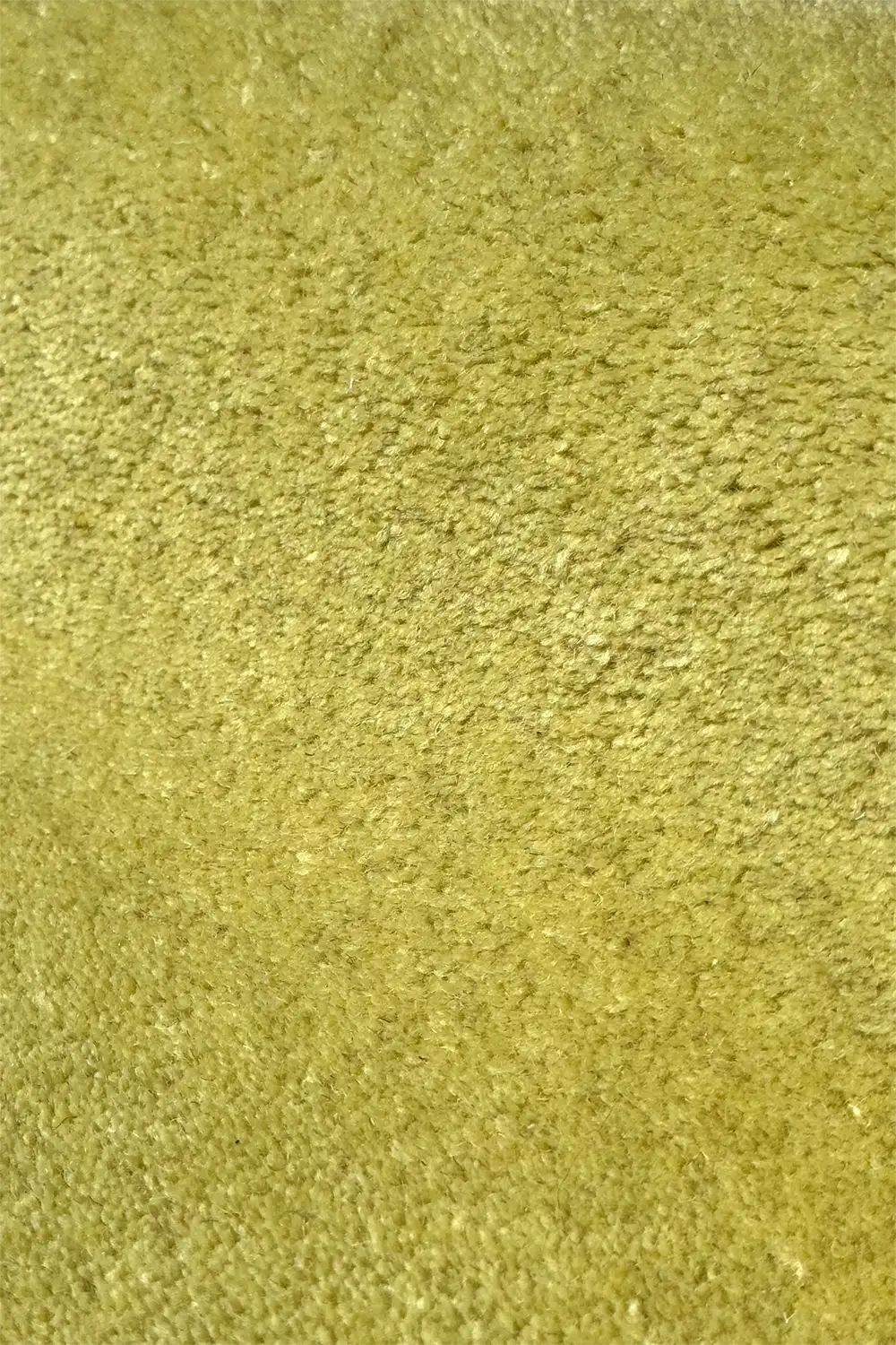 Close-up of a hand-tufted plush lime green wool area rug