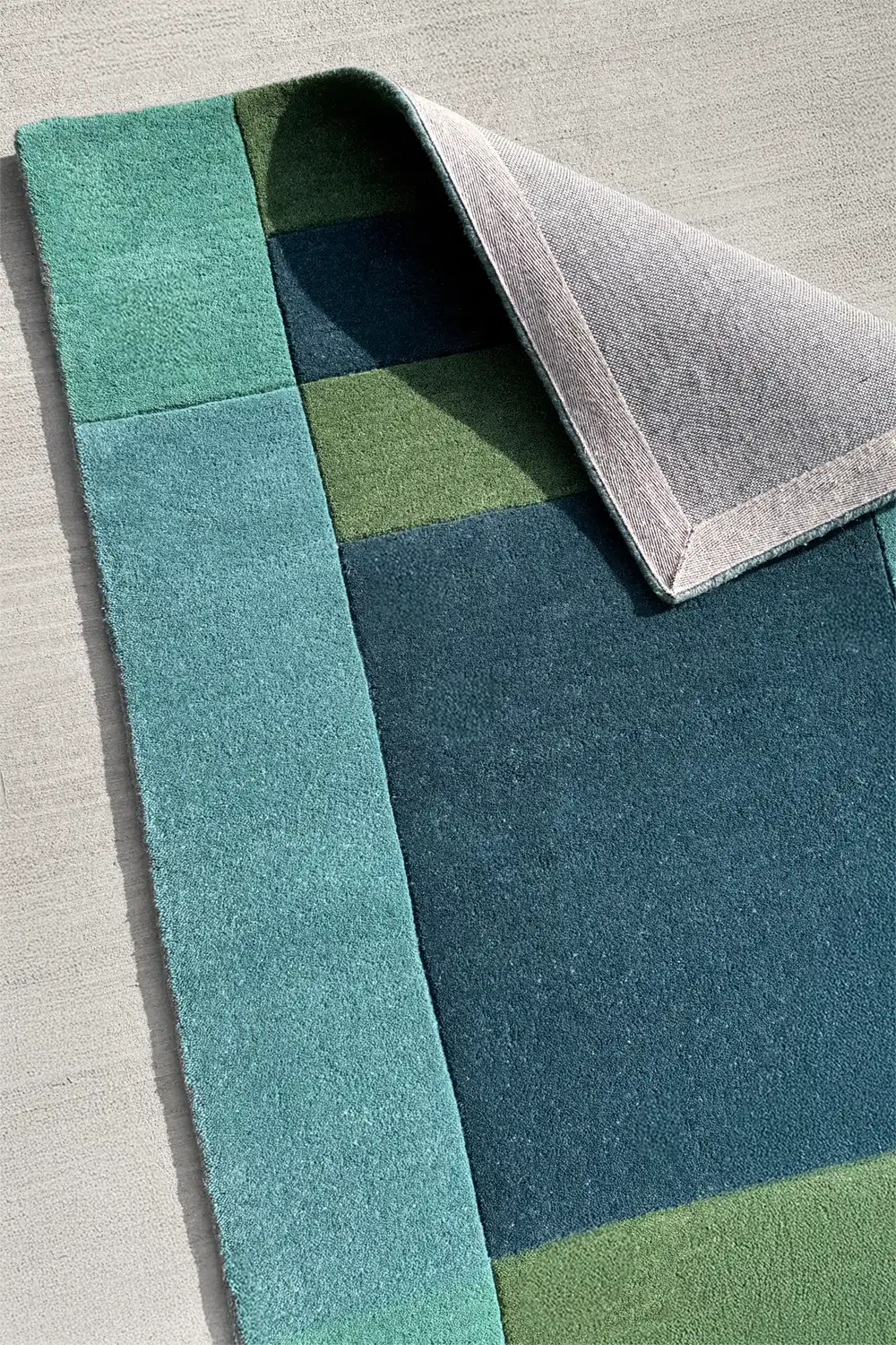Custom wool rug with durable cotton backing, handmade in multicolor graphic style