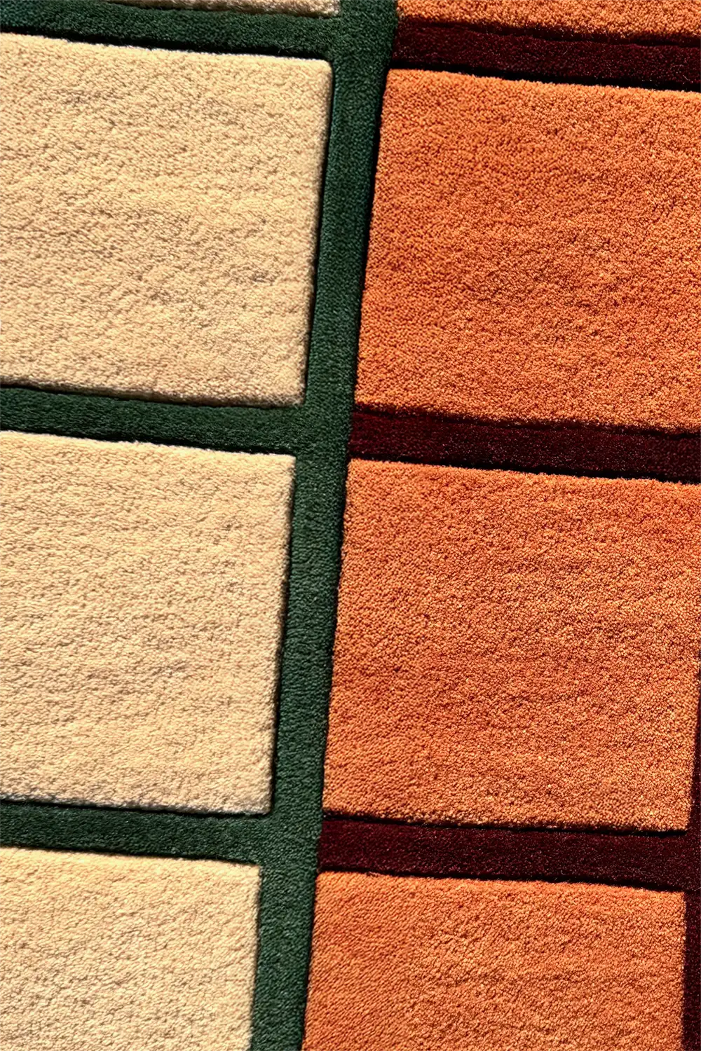 Close-up of a multicolor runner rug with square patterns in beige, orange, and green.