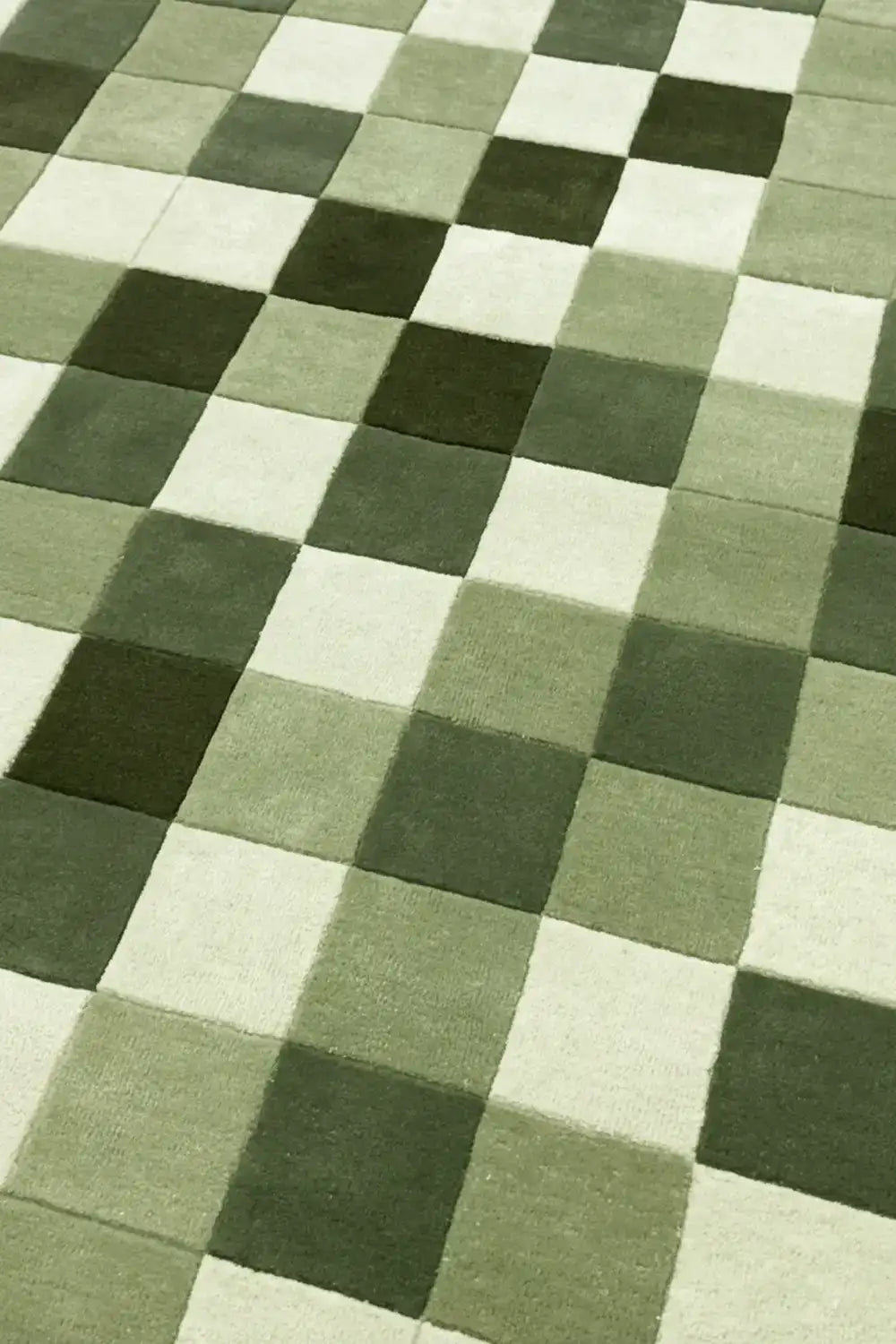 Checkered pattern rug with green and beige squares