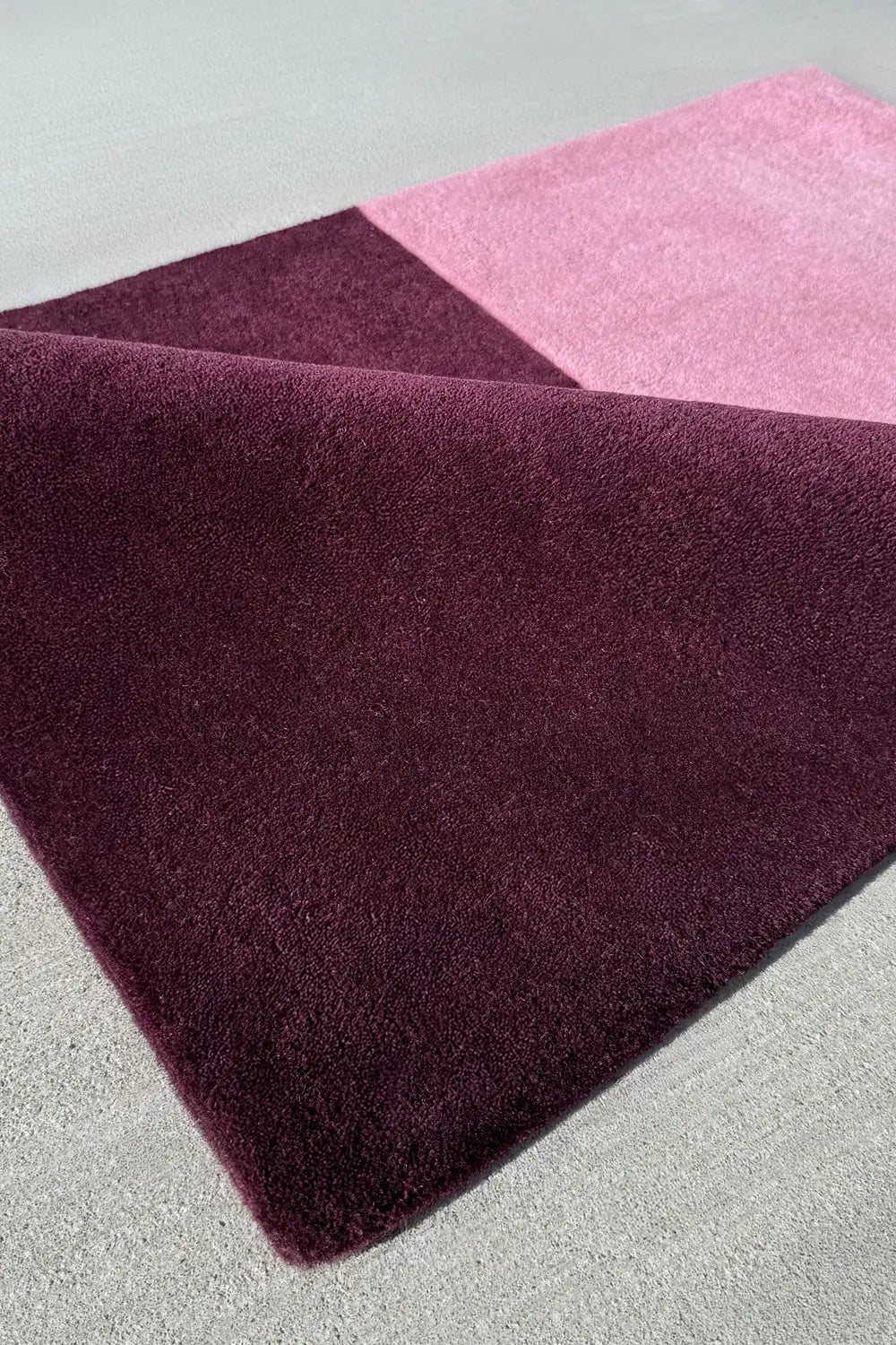 Pink and dark purple wool rug with sharp colorblock contrast, cute mauve rug for kids’ room or mid-century space