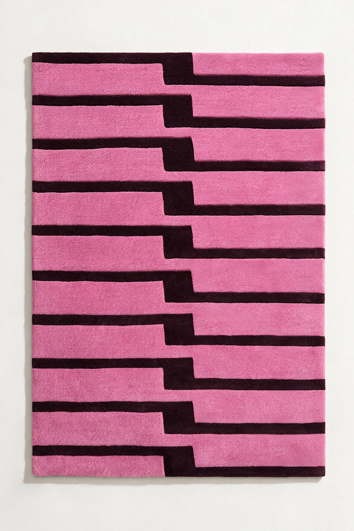 Pink and purple striped rug tufted wool rug on a white background