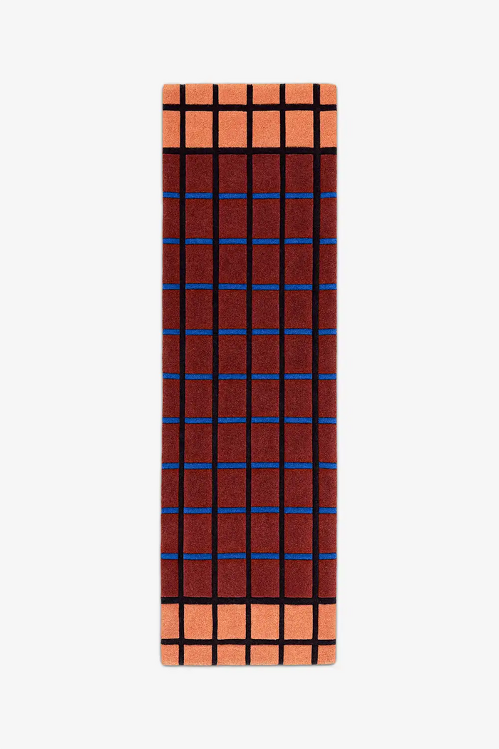 runner rug with a rust and terracotta grid pattern on a white background