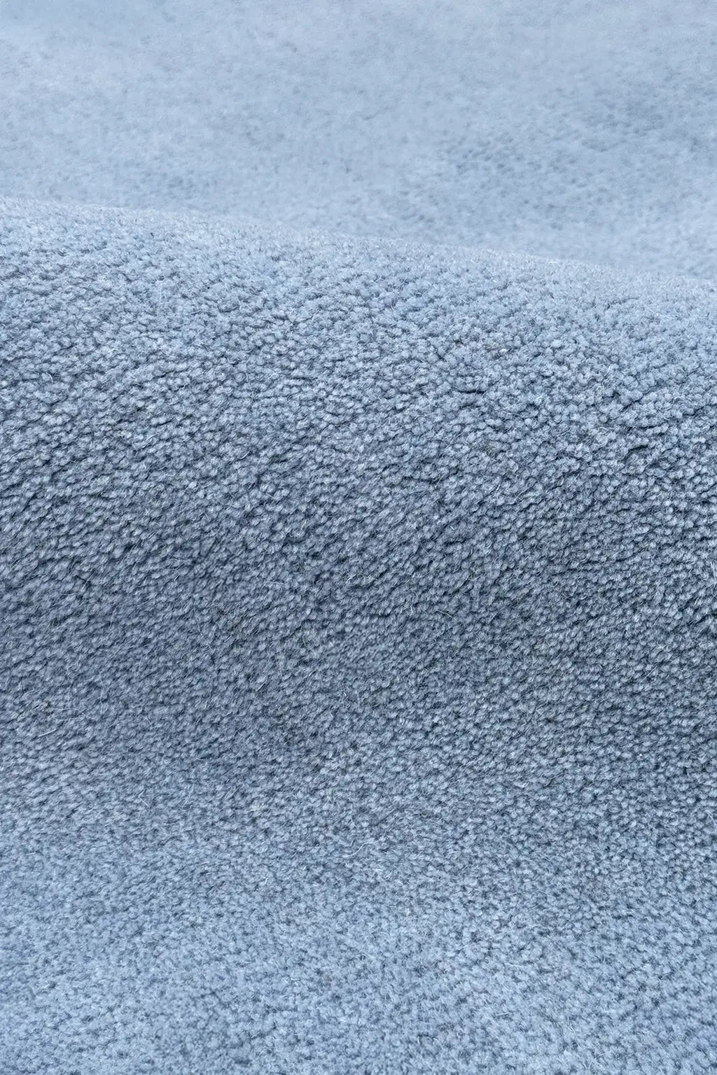 Close-up of a textured blue wool rug