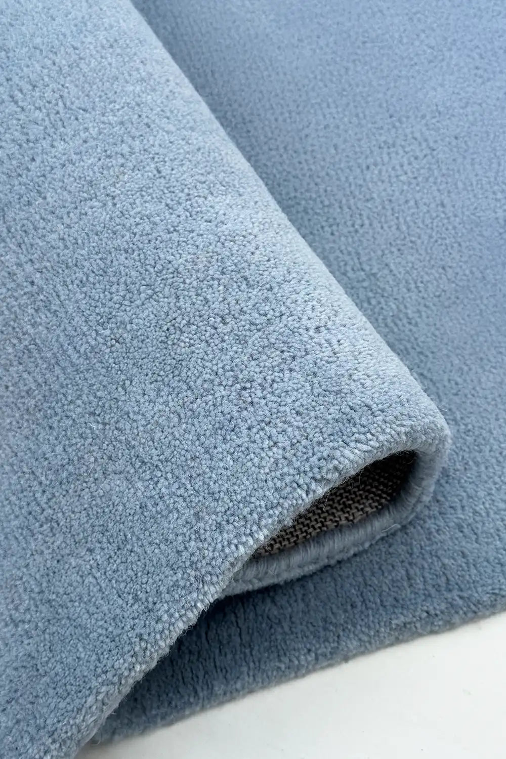 Close-up of a soft baby blue wool area rug