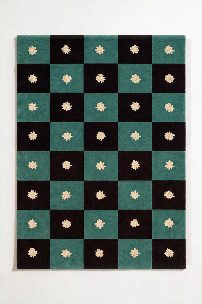 black and green checkered rug with star patterns on a white background