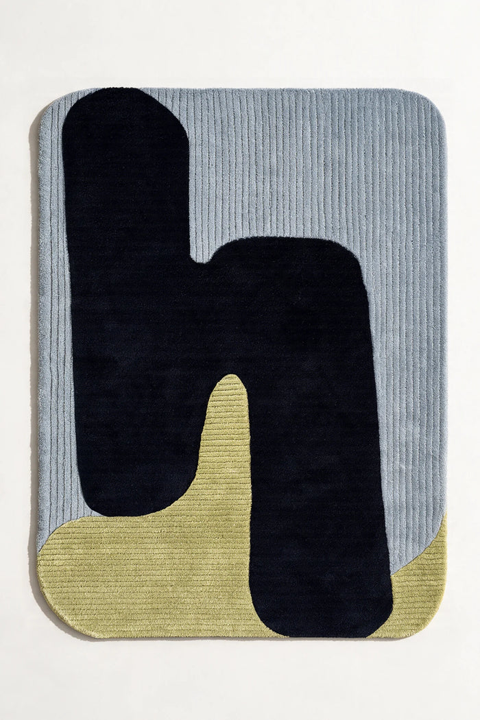 Irregular shaped navy blue and green 8x10 abstract rug with baby blue background, a modern wool rug perfect for living rooms or bedrooms