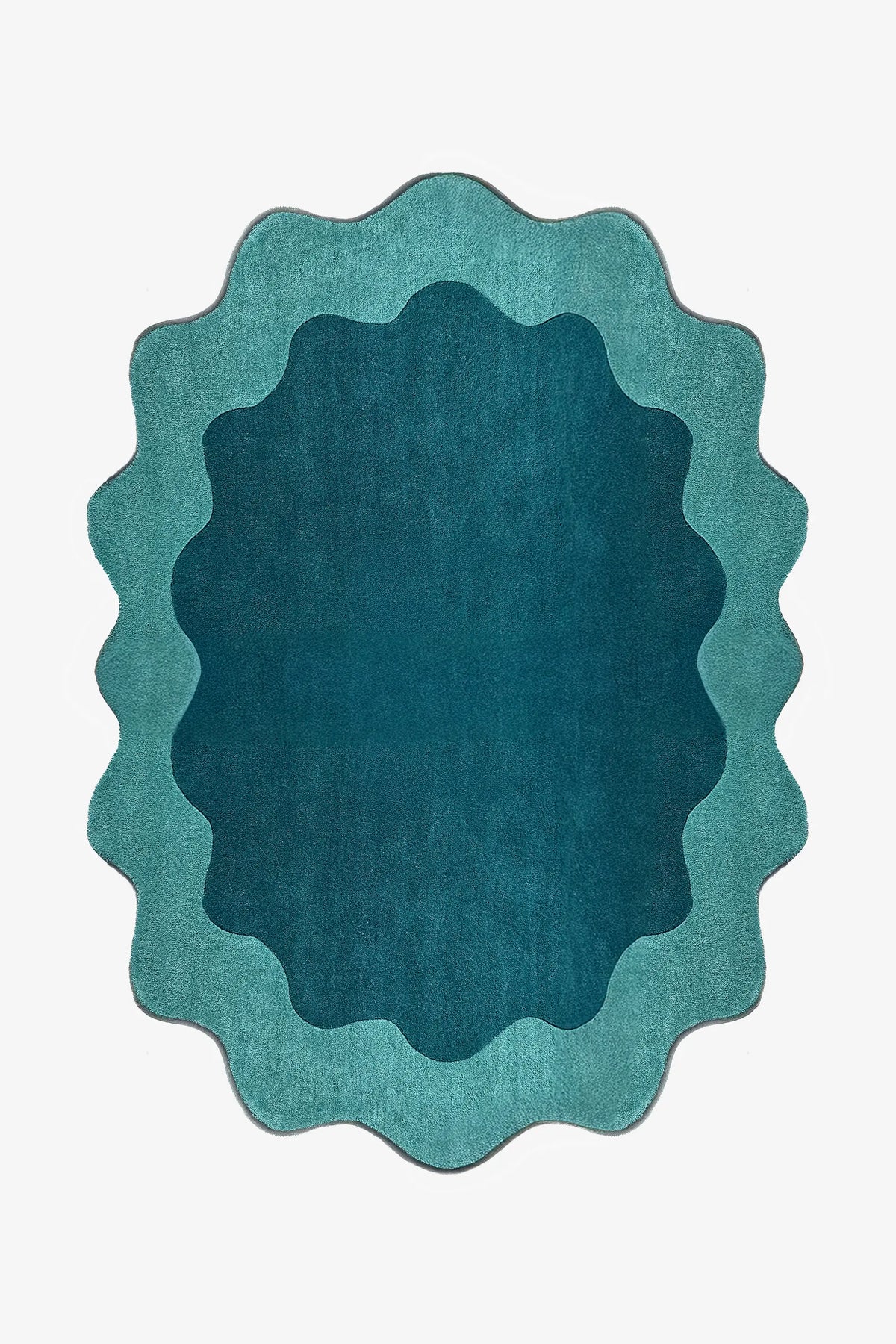Teal and turquoise scalloped edge rug with abstract curved silhouette, a bold 8x10 oval area rug for living rooms or bedrooms