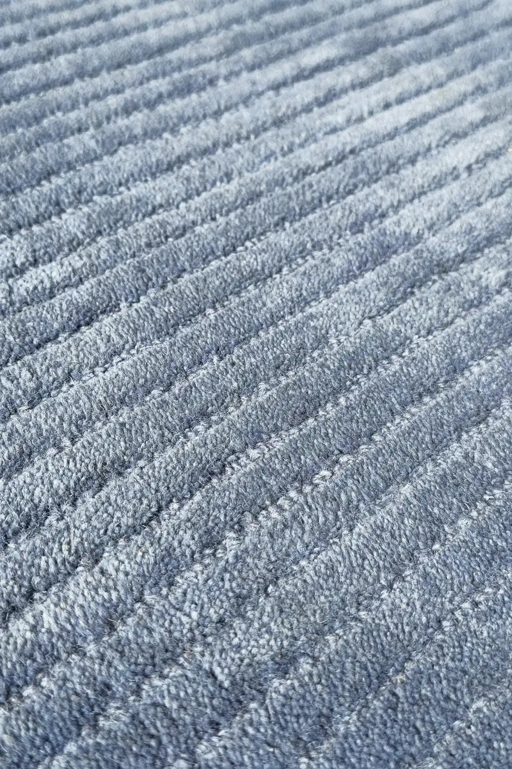 Soft baby blue textured wool area rug with plush movement and a modern feel