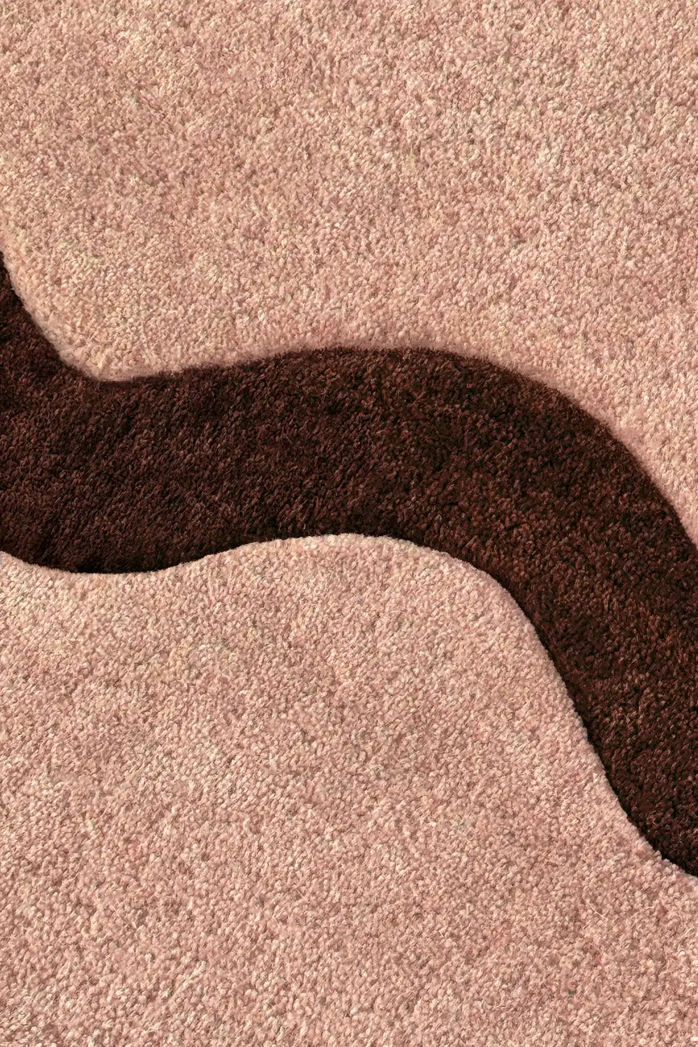 Detailed view of brown wave stripe on tan neutral rug, funky modern scalloped wool rug