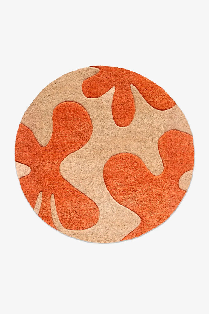 Hand-tufted modern round rug with orange and tan abstract floral pattern, wool 6ft rug