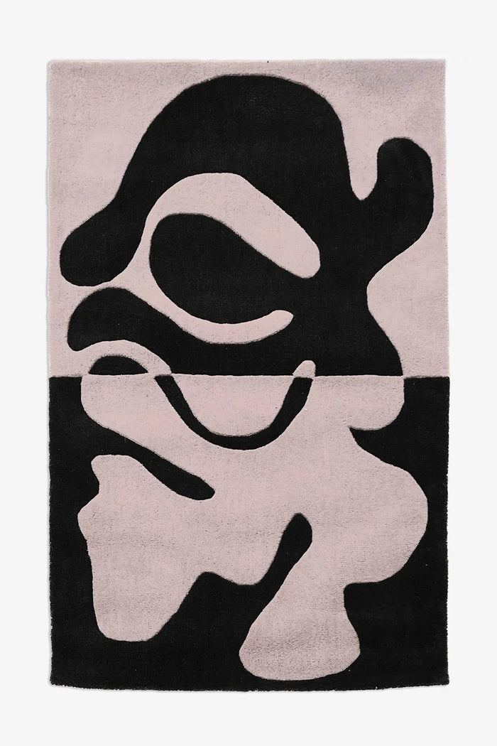 Two-tone black and white abstract rug with organic tufted forms