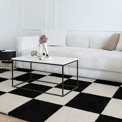 Bold black and white checkered rug in a minimalist white room, perfect for 8x10 rugs, modern checkered rugs, or funky rugs for living room