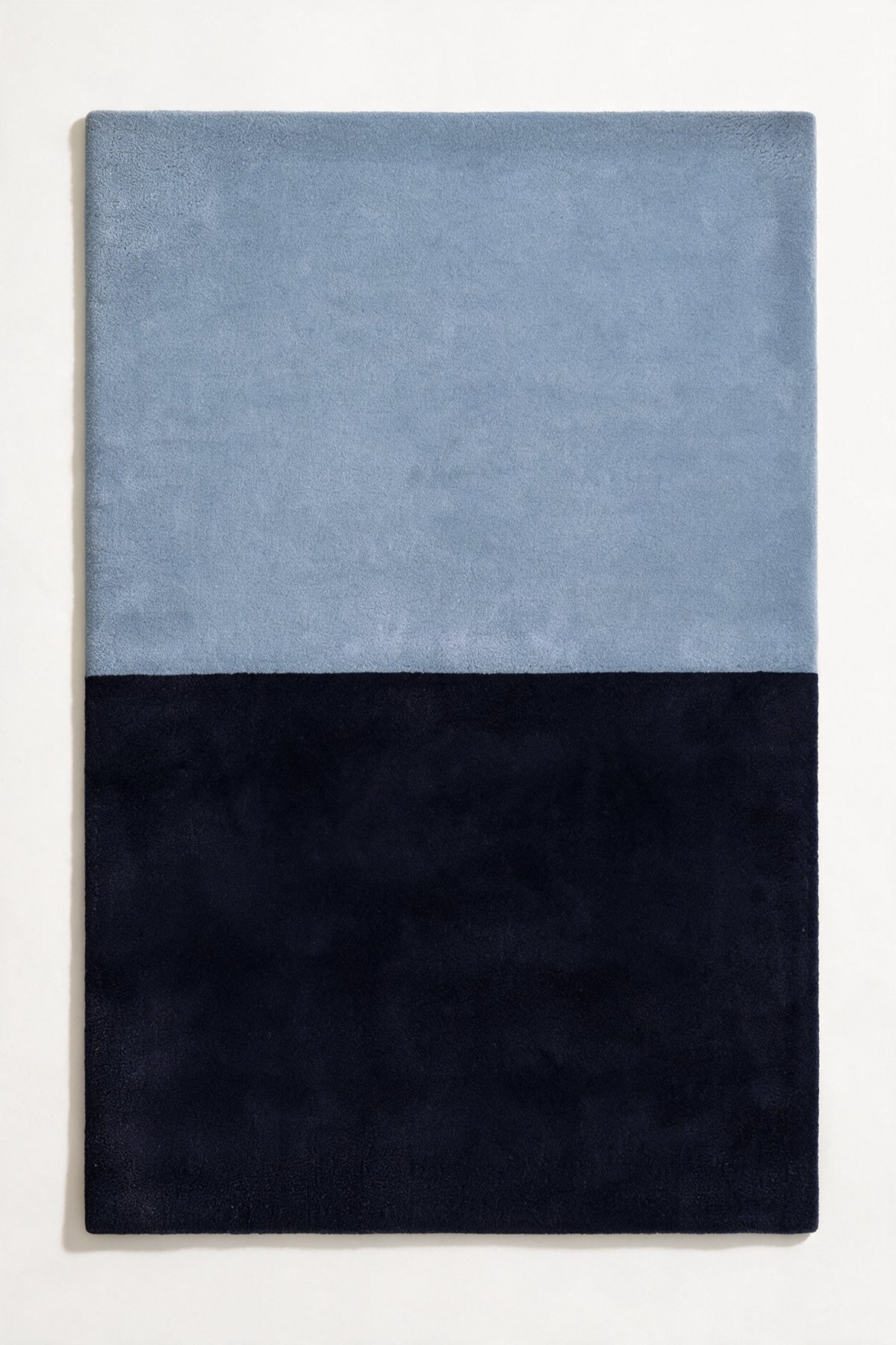 5x8 two-tone wool area rug in light blue and deep navy, perfect for modern bedrooms, serene offices, or minimalist living rooms indigo