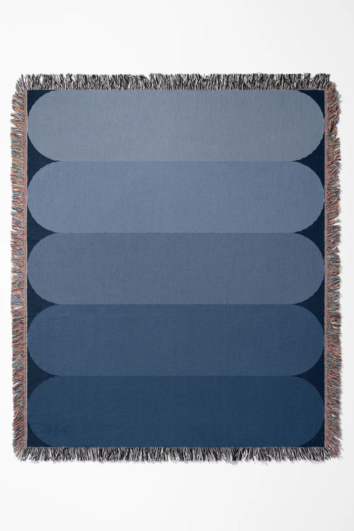 Blue gradient cotton woven throw blanket with soft ombré effect.