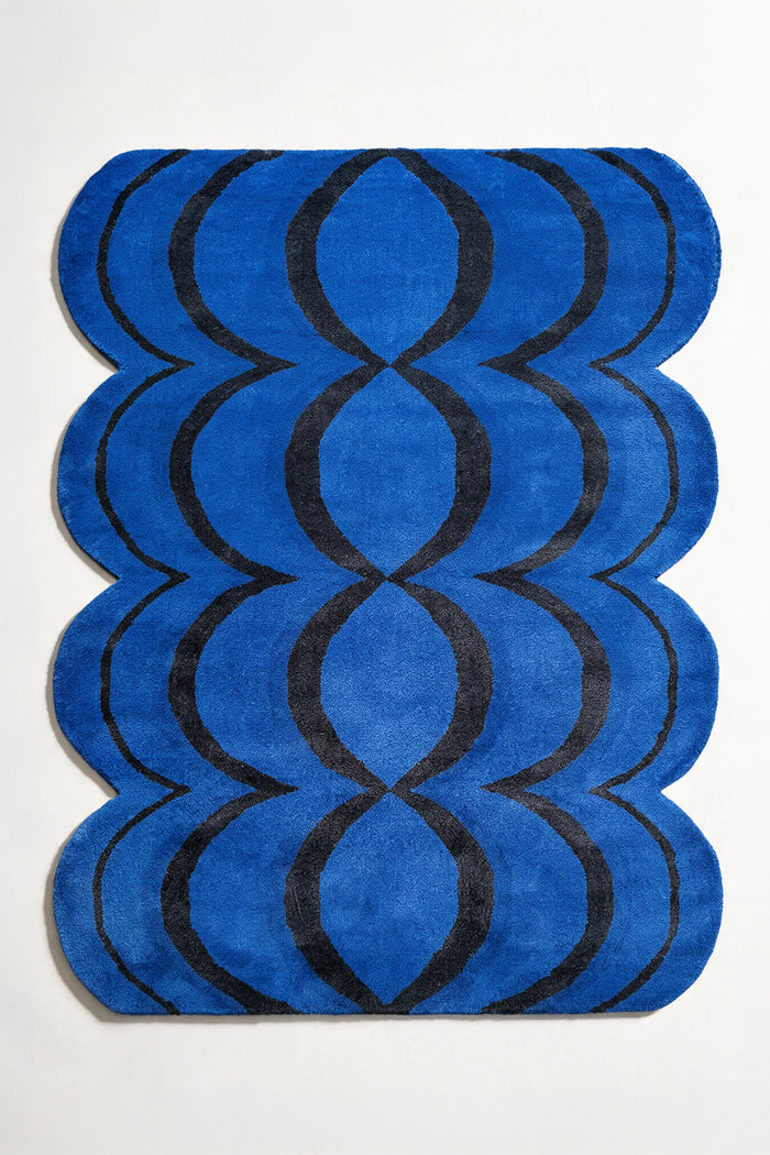 8x10 irregular shaped blue and black wool rug with ripple scalloped edges and funky design