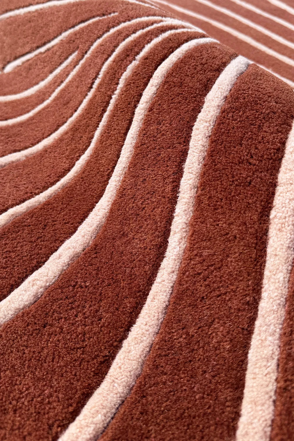 Mid century inspired rust oval rug with plush cream stripes and dimensional wool carving