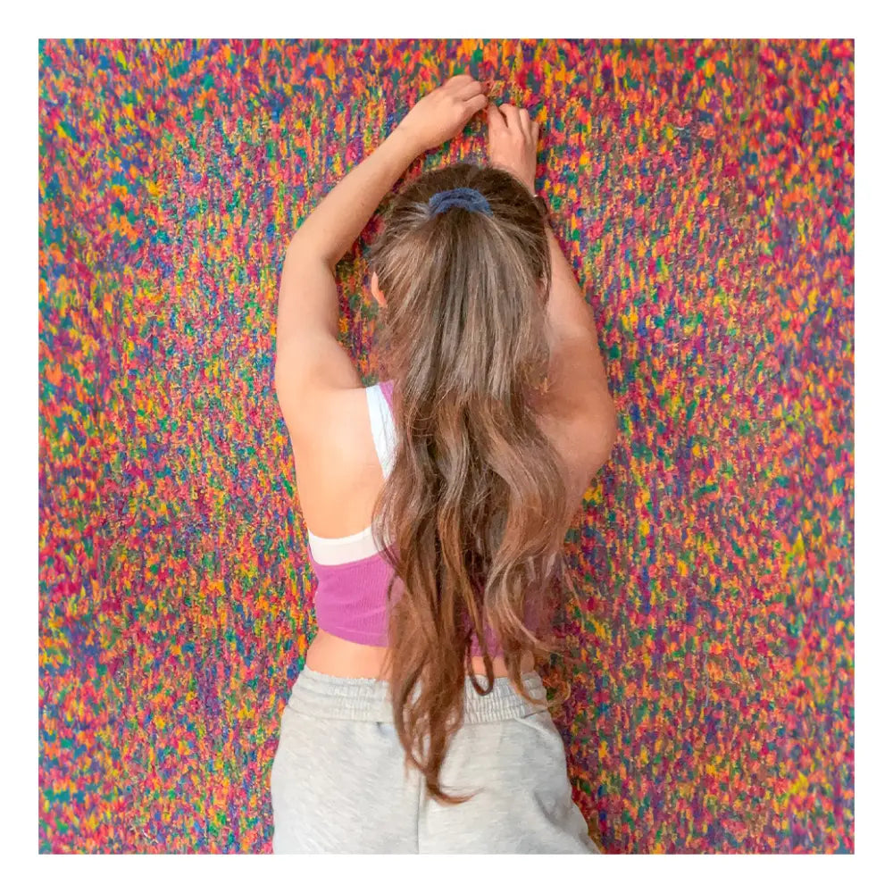 Cassie with a colorful modern wool rug, part of Jubi’s original handmade collection